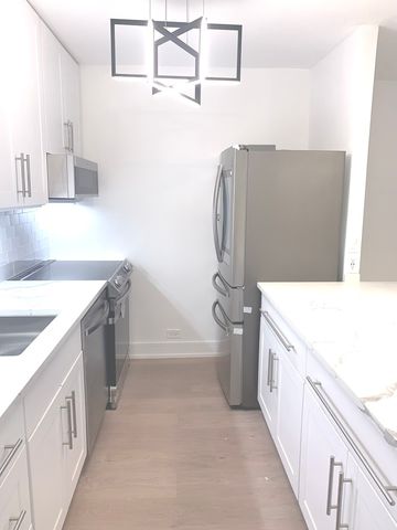 a bathroom with a granite countertop sink a toilet and bathtub