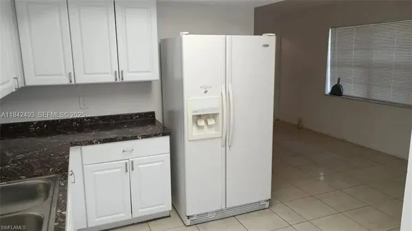 a white refrigerator freezer sitting inside of a kitchen
