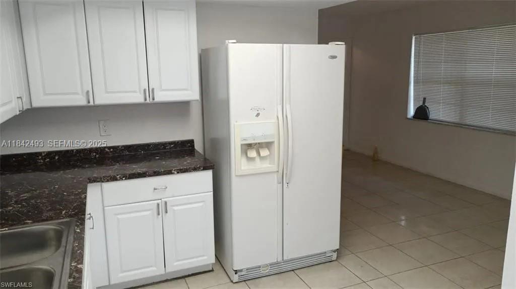 2524 Congress Street, Unit 4 Fort Myers, FL 33901 - Photo 13 of 24 a white refrigerator freezer sitting inside of a kitchen