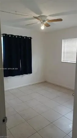 a view of an empty room and a window