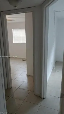 a view of an empty room and a window