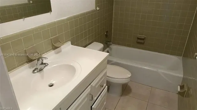 a bathroom with a sink a toilet and bathtub