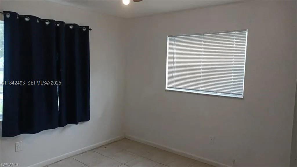 2524 Congress Street, Unit 4 Fort Myers, FL 33901 - Photo 19 of 24 an empty room with wooden floor and cabinet