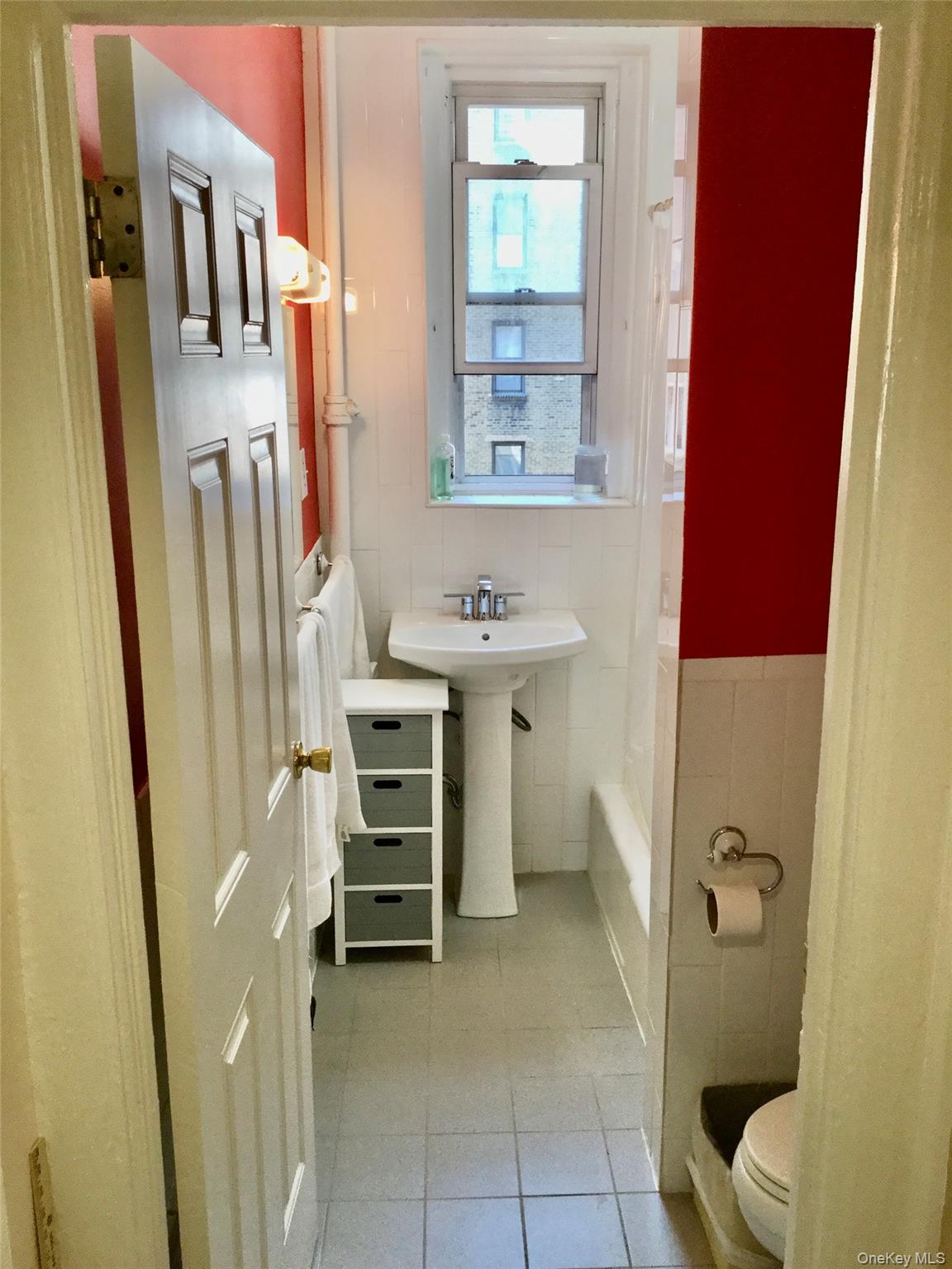 35-20 82nd Street, Unit 31J Queens, NY 11372 - Photo 9 of 10 Full bathroom with tile walls and light tile patterned floors