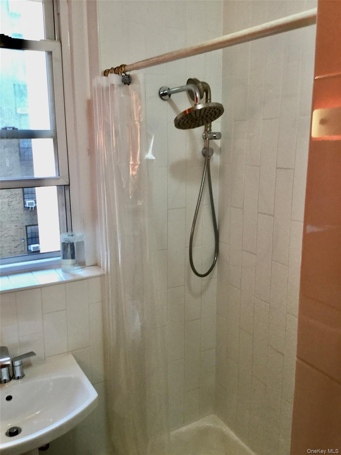 35-20 82nd Street, Unit 31J Queens, NY 11372 - Photo 10 of 10 Full bath featuring a stall shower and a sink