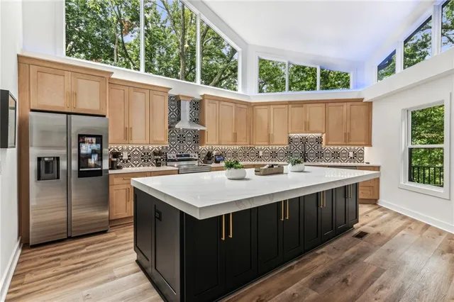 a view of a balcony with chairs and wooden floor