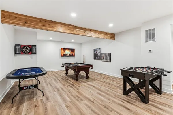 a balcony with table and chairs and a large tree