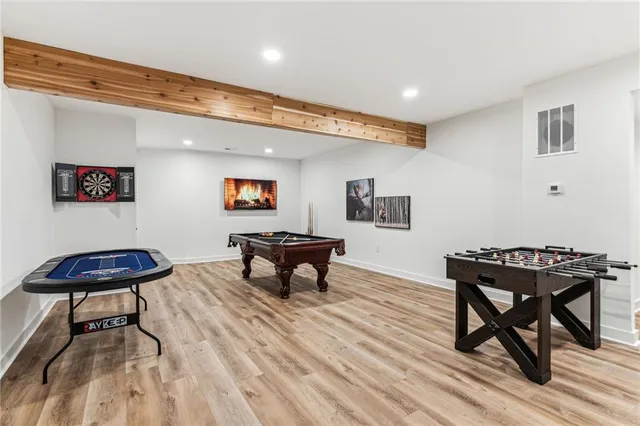 a balcony with table and chairs and a large tree
