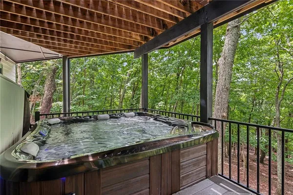 a view of backyard with wooden fence and a bench