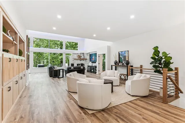 a view of a patio with a table and chairs with wooden floor and fence