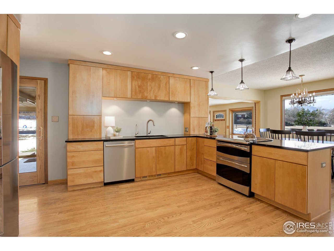 7714 Baseline Road Boulder, CO 80303 - Photo 11 of 38 a kitchen with stainless steel appliances kitchen island granite countertop a refrigerator and a stove top oven