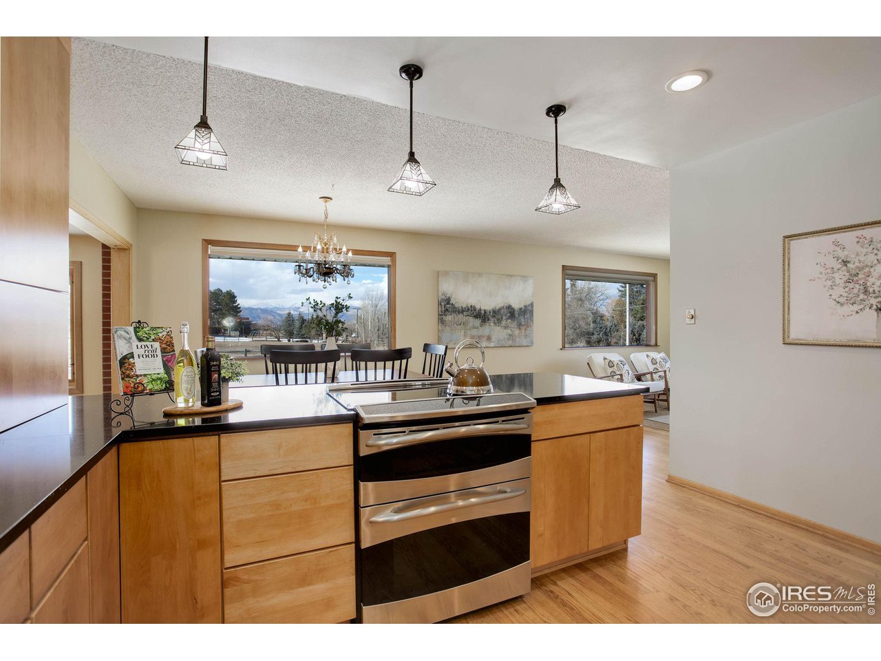 7714 Baseline Road Boulder, CO 80303 - Photo 13 of 38 a kitchen with stainless steel appliances kitchen island granite countertop a sink and wooden floor