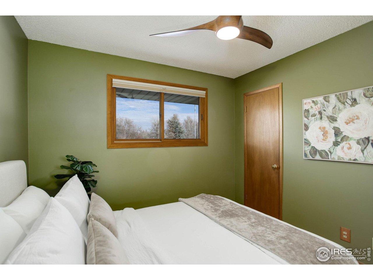 7714 Baseline Road Boulder, CO 80303 - Photo 27 of 38 a bedroom with a bed and a painting on the wall