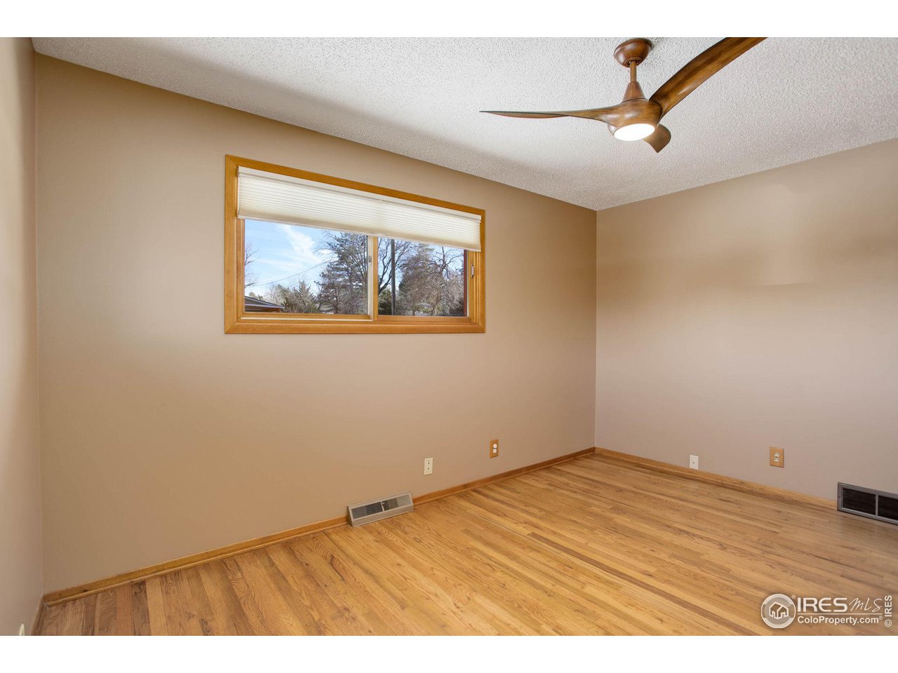 7714 Baseline Road Boulder, CO 80303 - Photo 29 of 38 an empty room with a window and ceiling fan