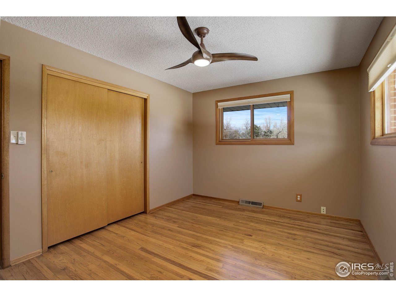 7714 Baseline Road Boulder, CO 80303 - Photo 30 of 38 a view of an empty room with wooden floor and a window