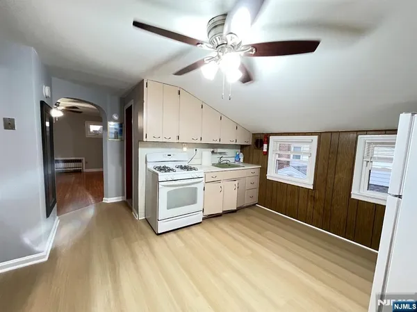 a view of a kitchen with stainless steel appliances a sink and a refrigerator