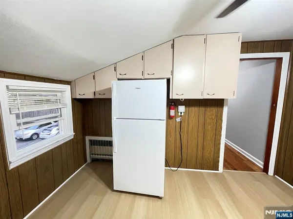 a white refrigerator freezer sitting in a kitchen