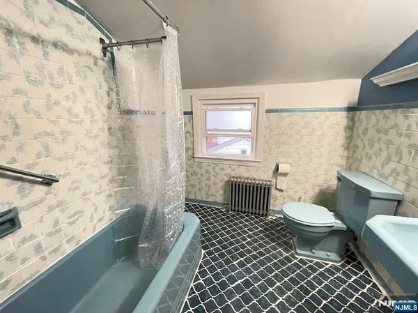 a bathroom with a toilet a sink and a shower