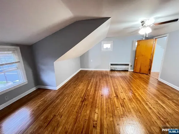 a view of a room with wooden floor and staircase