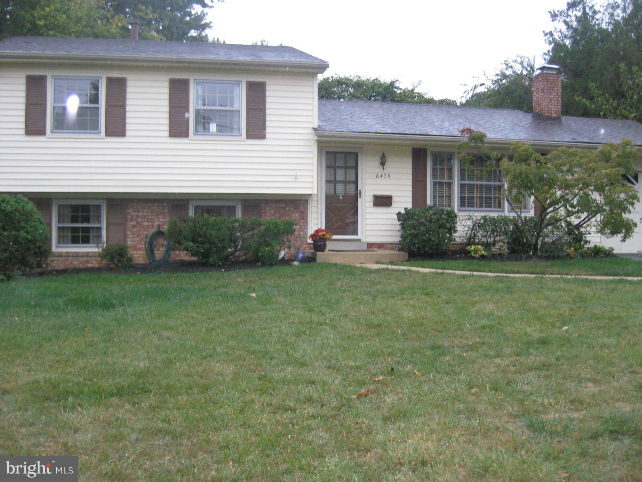 6405 Meriwether Lane Springfield, VA 22150 - Photo 1 of 14 a front view of house with yard and green space
