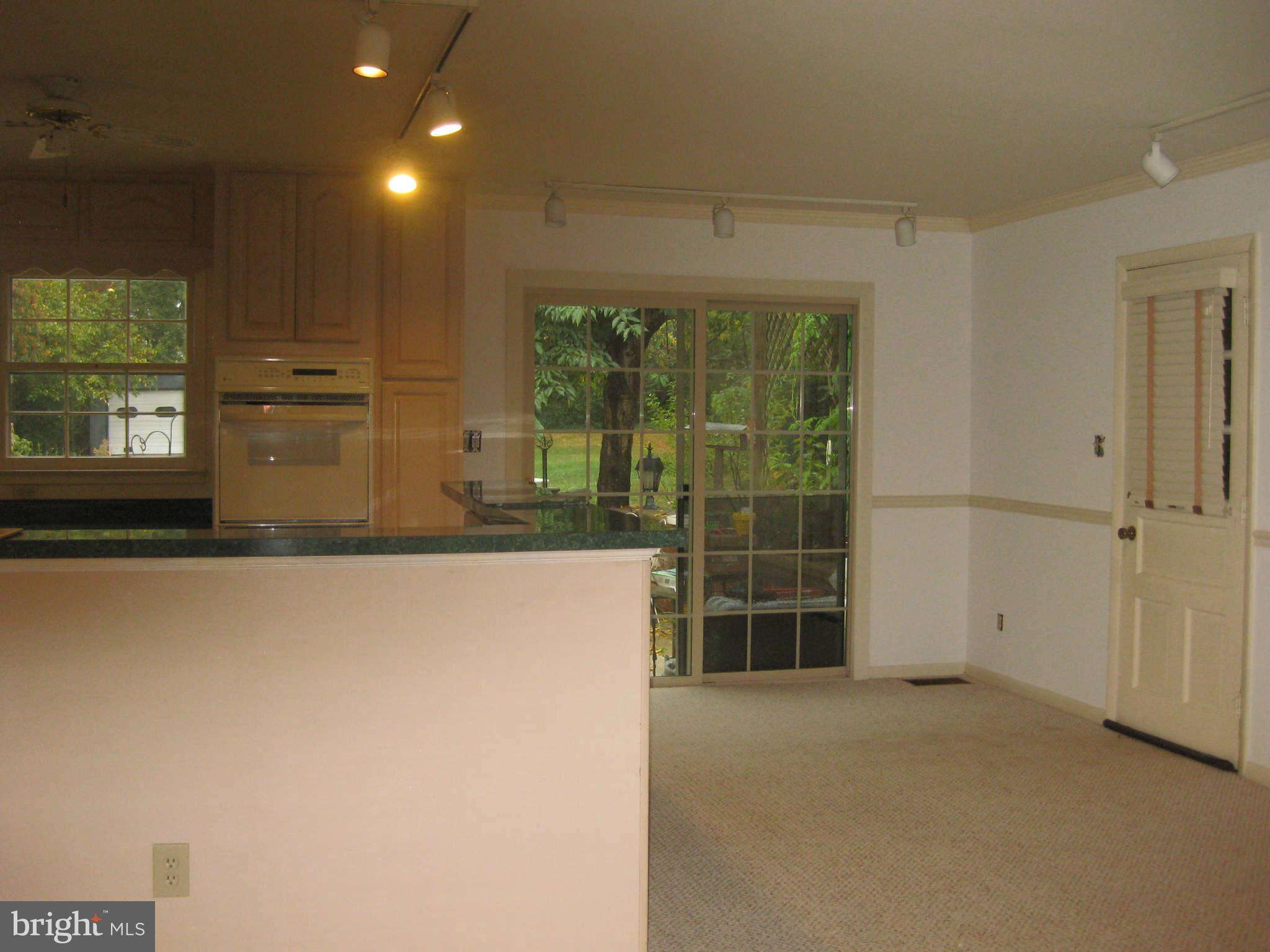 6405 Meriwether Lane Springfield, VA 22150 - Photo 3 of 14 a view of a kitchen with furniture and large windows