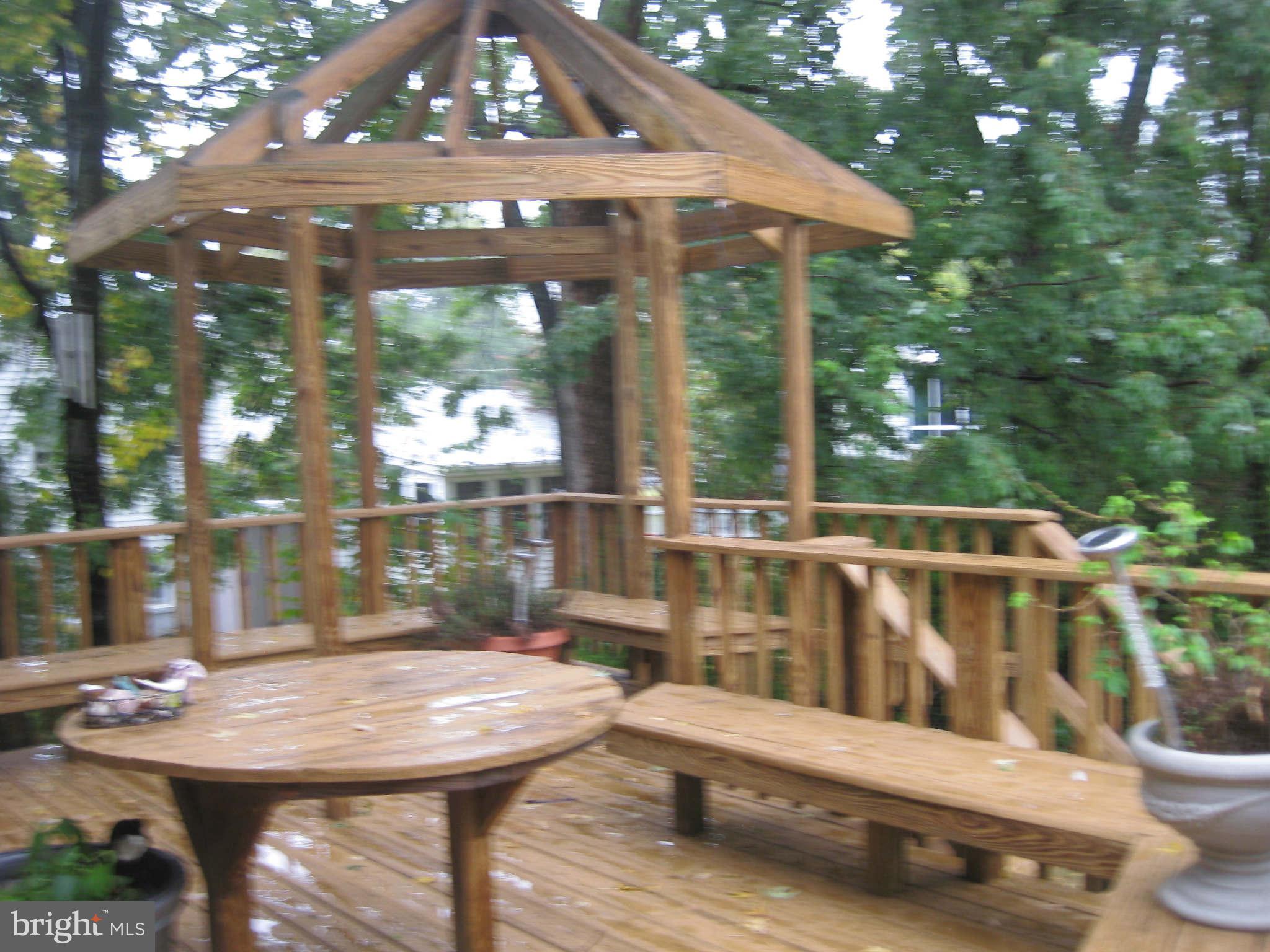 6405 Meriwether Lane Springfield, VA 22150 - Photo 10 of 14 a view of a patio with a table chairs and a small yard