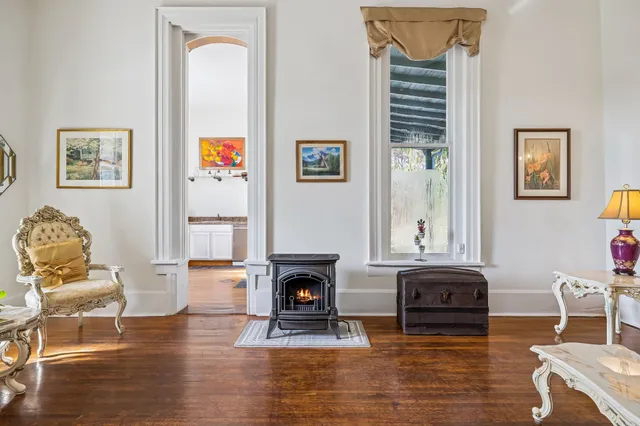 a living room with dining room and wooden floor