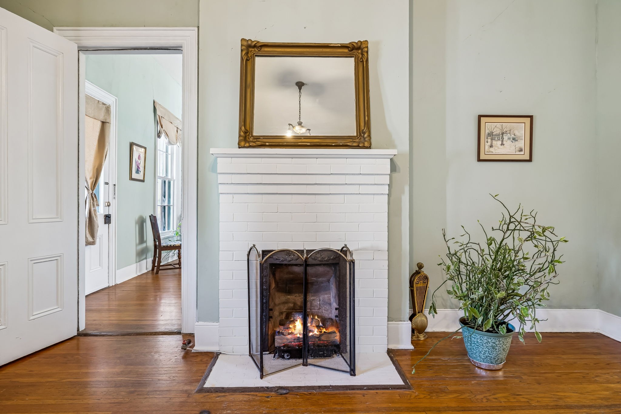 375 Highway 13 Waverly, TN 37185 - Photo 24 of 80 a living room with a fireplace and wooden floor