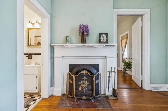 a living room with furniture a fireplace and a table