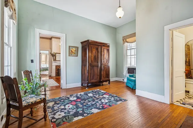 a view of a house with large windows and a small yard