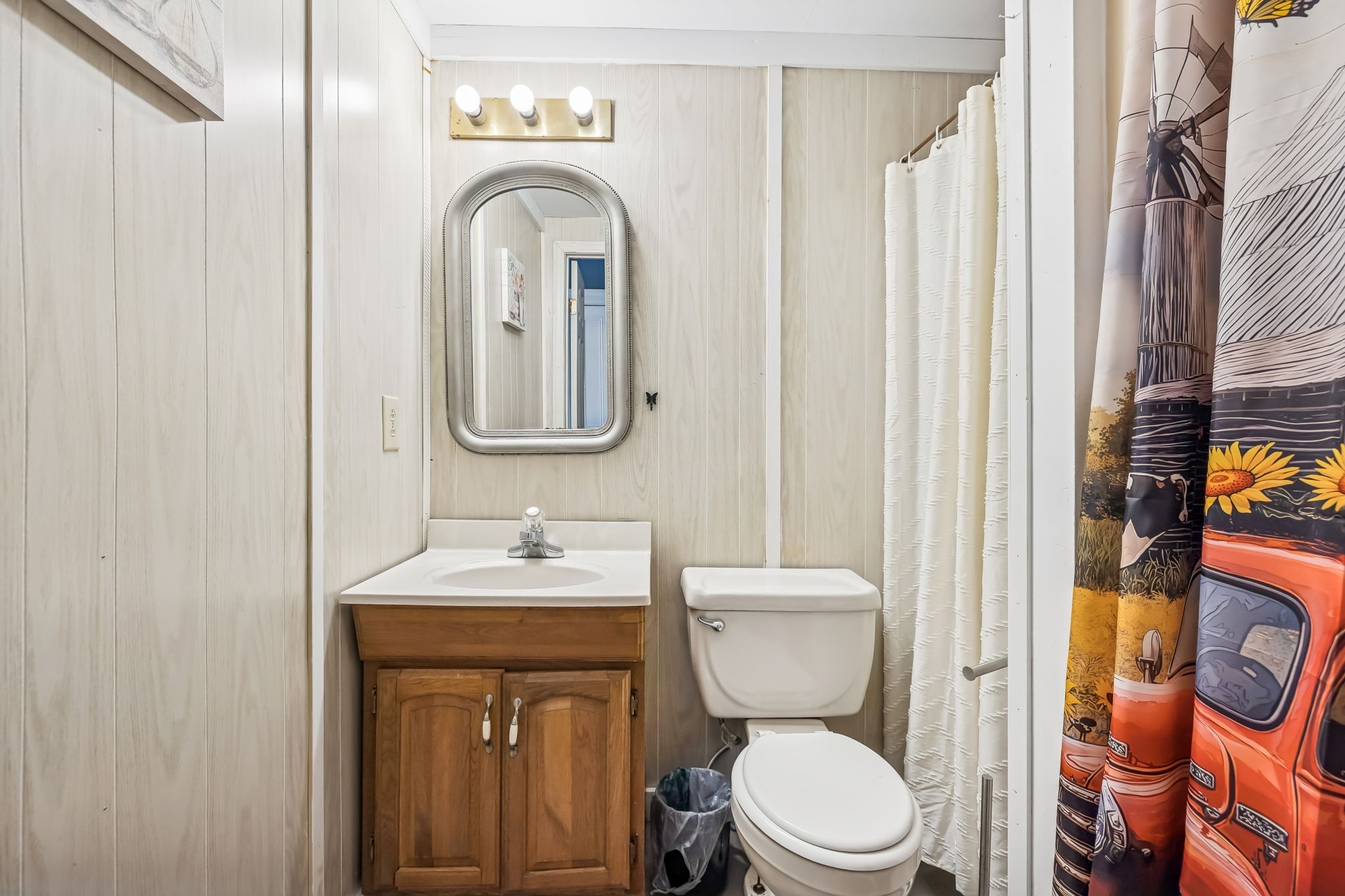 375 Highway 13 Waverly, TN 37185 - Photo 36 of 80 a bathroom with a toilet sink and mirror