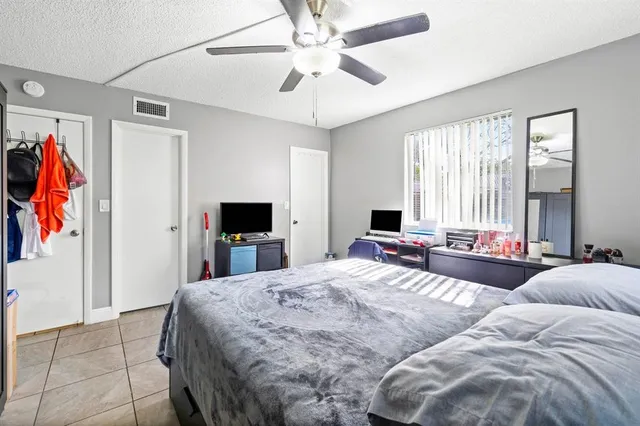 a bathroom with a granite countertop toilet sink and mirror