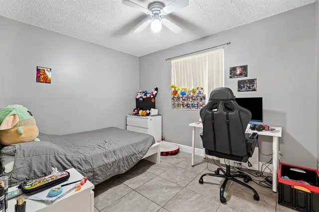 a bathroom with a granite countertop sink a toilet and bathtub