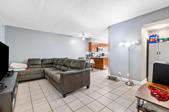 a kitchen with stainless steel appliances granite countertop a stove top oven a sink dishwasher and a microwave oven on the blue kitchen countertops