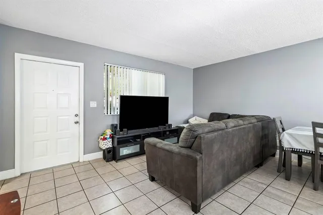 a spacious bedroom with a bed and a chandelier