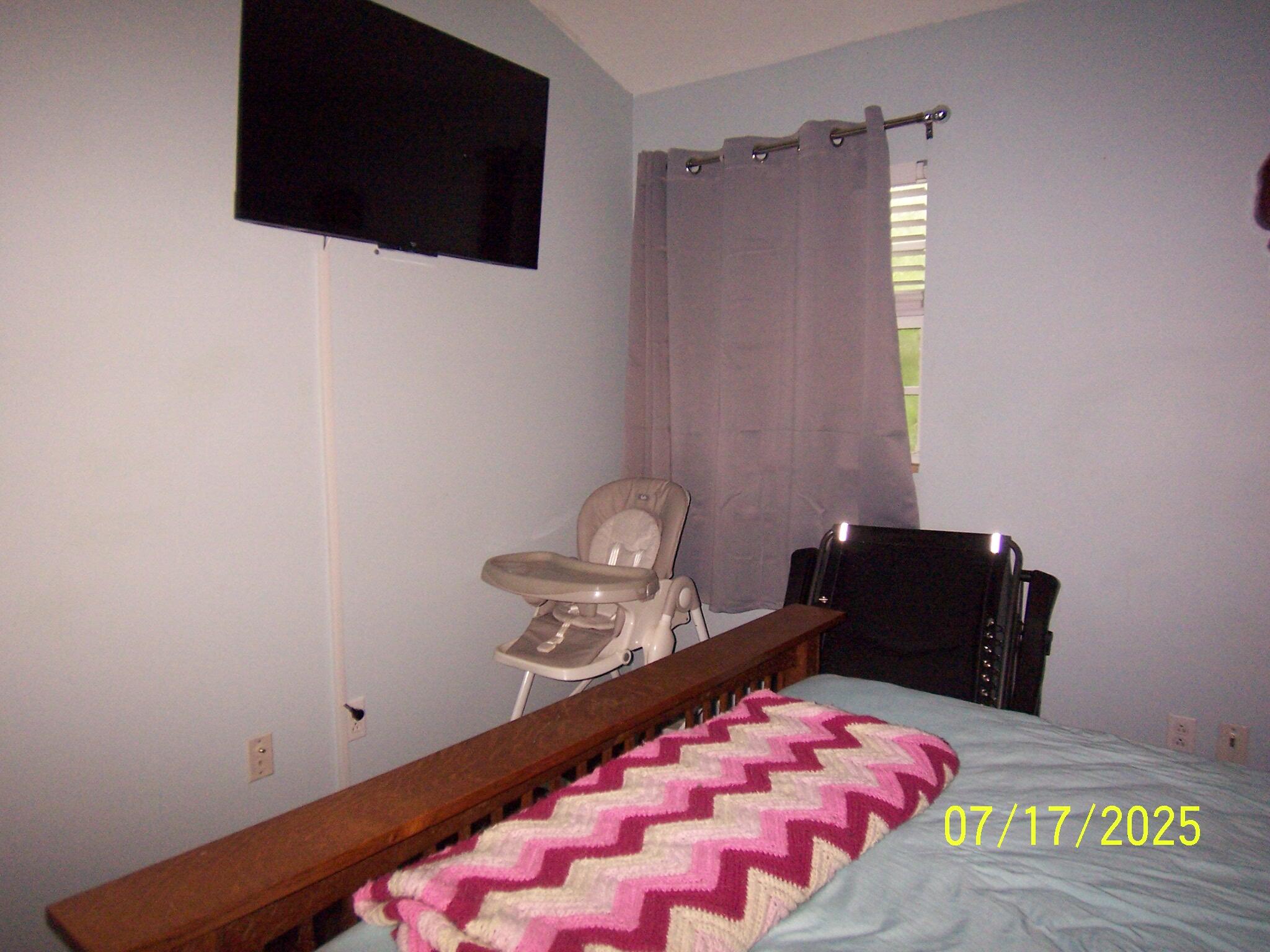 Undisclosed Address Key Largo, FL 33037 - Photo 12 of 19 a bedroom with a bed and a flat screen tv