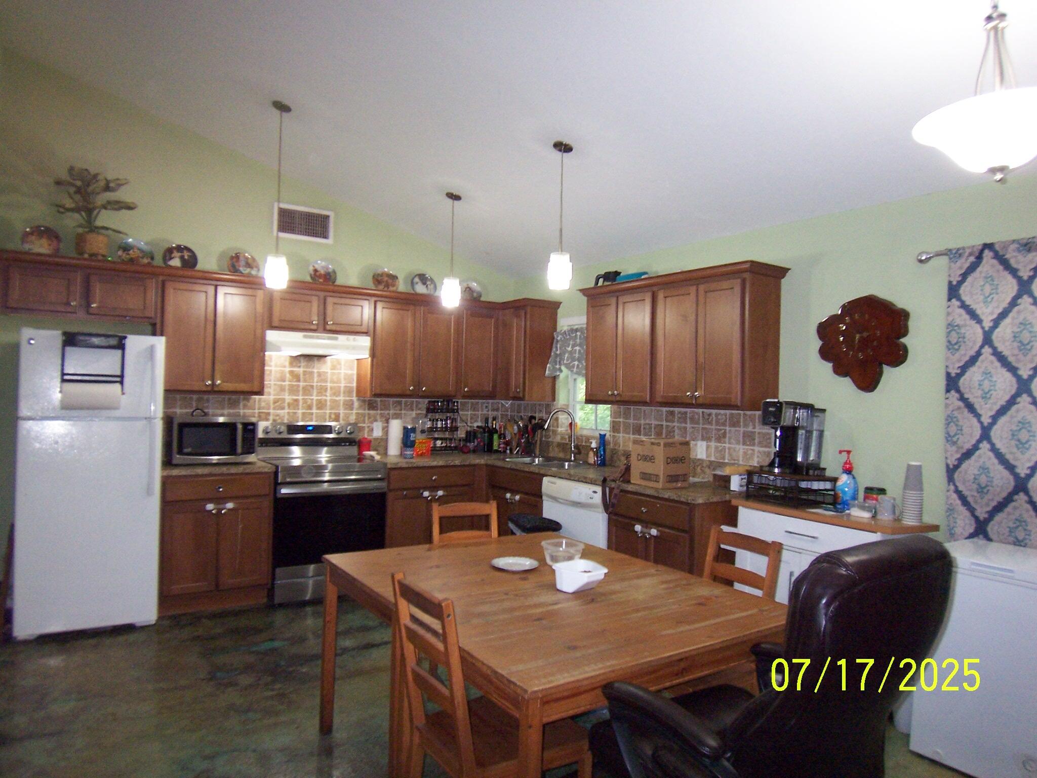 Undisclosed Address Key Largo, FL 33037 - Photo 4 of 19 a kitchen with granite countertop a sink appliances and cabinets