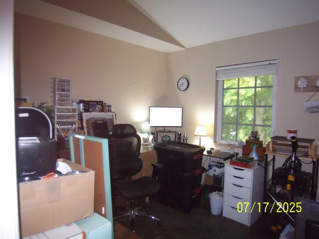 a view of a livingroom with furniture and a window