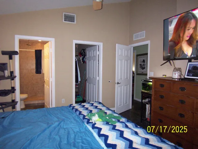 a bedroom with a bed and a dresser in it