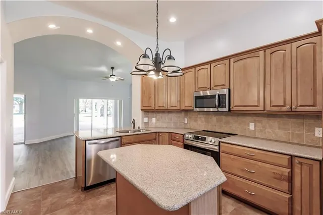 an empty room with wooden floor and window