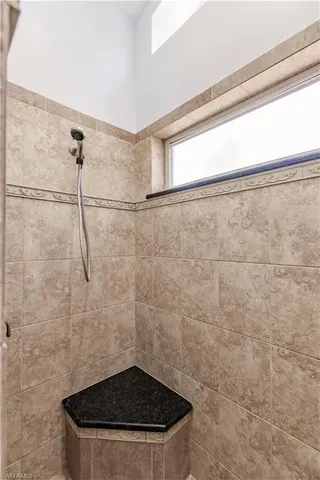 a bathroom with a granite countertop sink toilet a mirror and shower