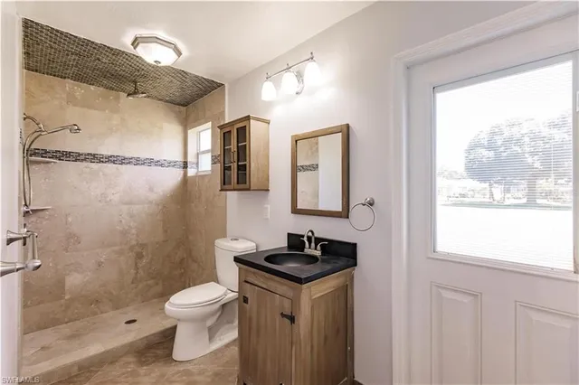 a bathroom with a sink vanity and mirror