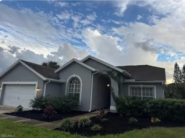 a front view of a house with a garden