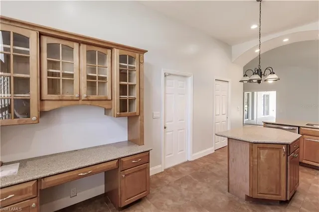 a kitchen with stainless steel appliances granite countertop a sink dishwasher and white cabinets with wooden floor