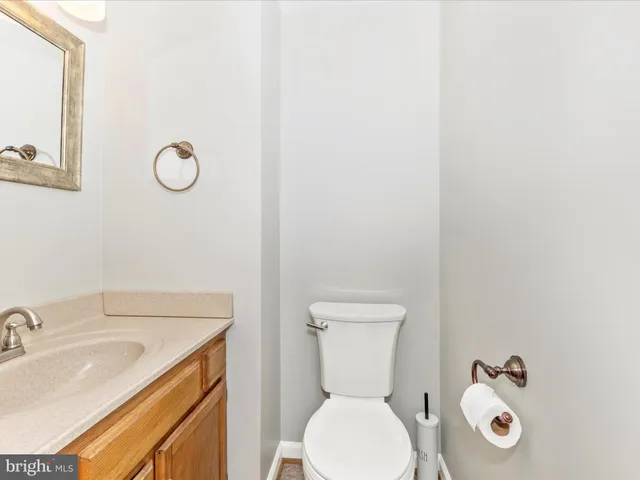 a white toilet sitting next to a bathroom sink