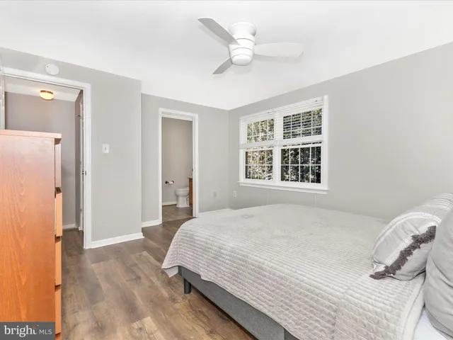 a view of a room with wooden floor and window