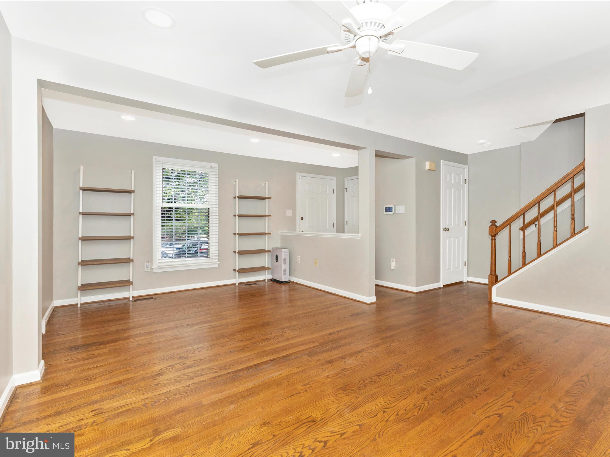 8204 Red Wing Court Frederick, MD 21701 - Photo 4 of 72 a view of an empty room with a window and wooden floor