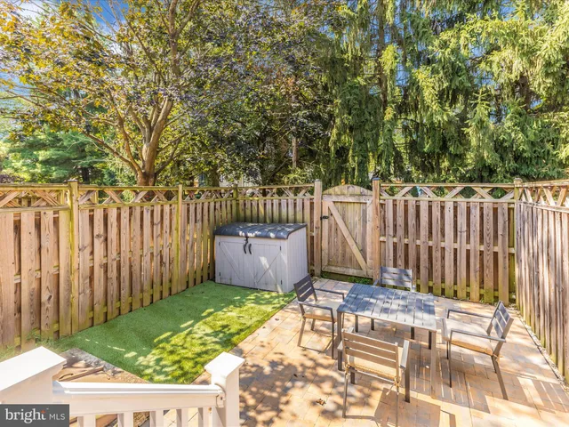 a view of tennis court with lots of trees