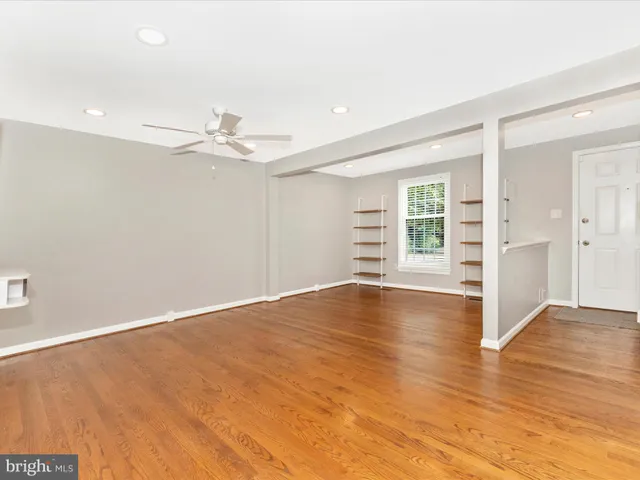 a view of a livingroom with wooden floor and a flat screen tv