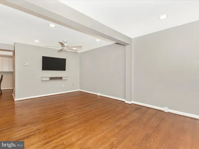 a kitchen with stainless steel appliances white cabinets and a refrigerator